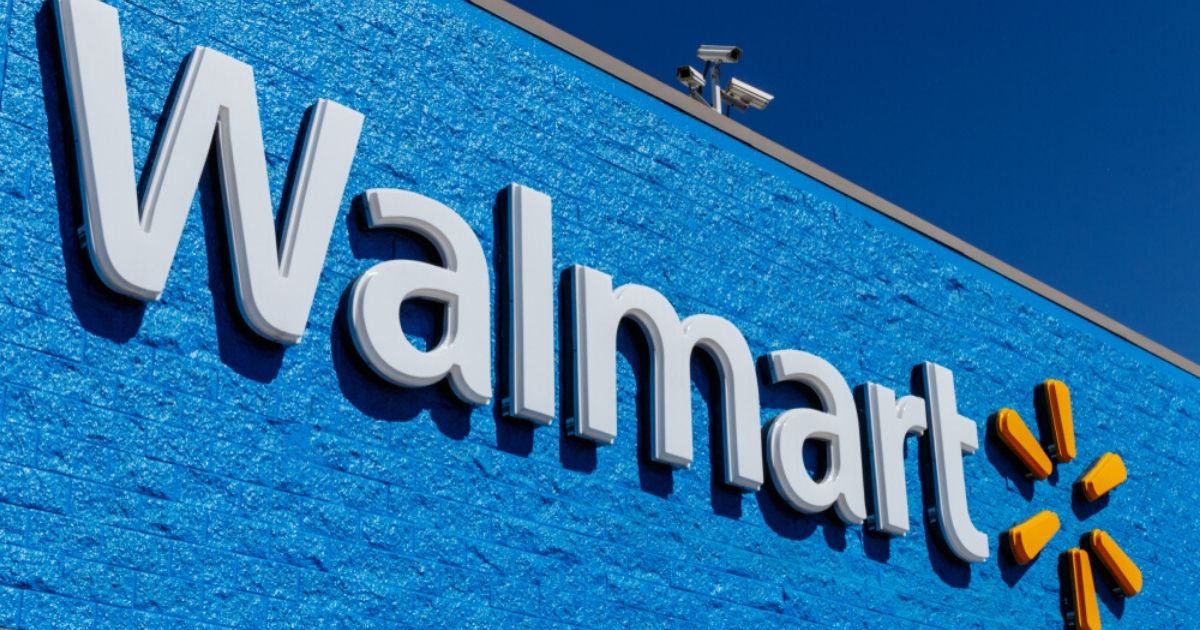 Walmart signage is seen on a store in the image above. Over 100 locations will be offering drive-in movie nights this summer.