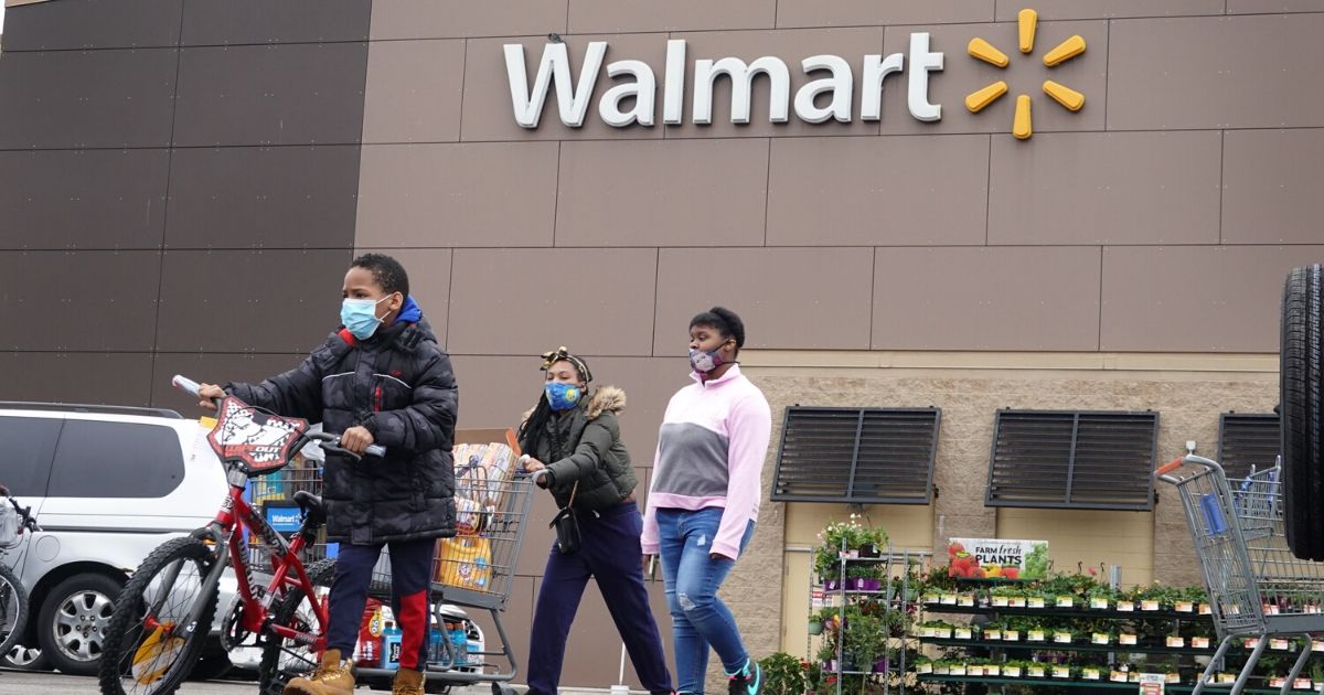 Customers wearing masks shop at a Walmart store on May 19, 2020, in Chicago, Illinois. Walmart will require customers nationwide to wear masks beginning July 20, 2020.