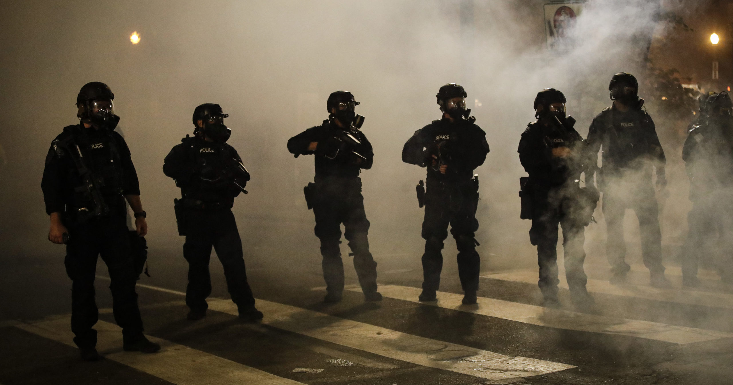 Federal officers are surrounded by smoke as they push back rioters during a Black Lives Matter protest at the Mark O. Hatfield United States Courthouse on July 29, 2020, in Portland, Oregon.