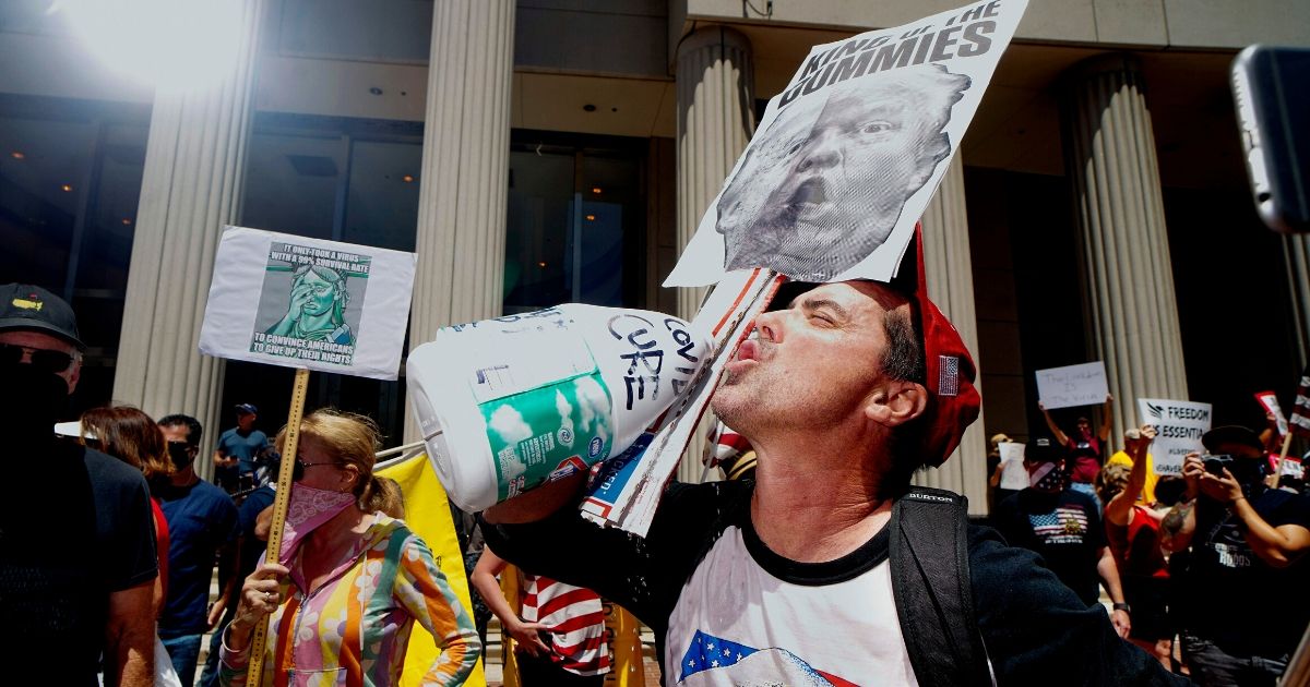 A demonstrator holding an anti-Trump sign