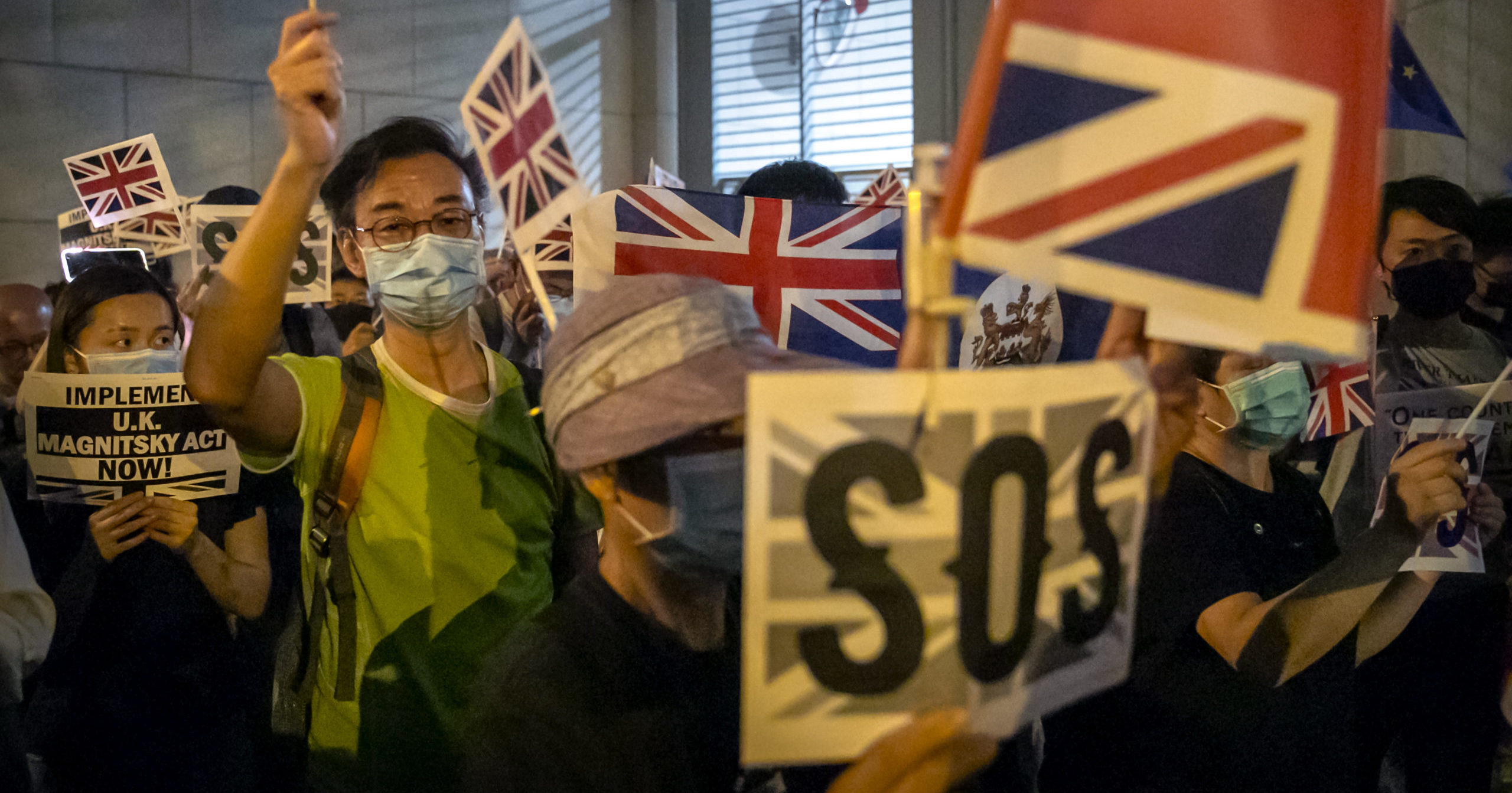 In this Oct. 23, 2019, file photo, demonstrators wave British flags during a rally outside the British Consulate in Hong Kong.