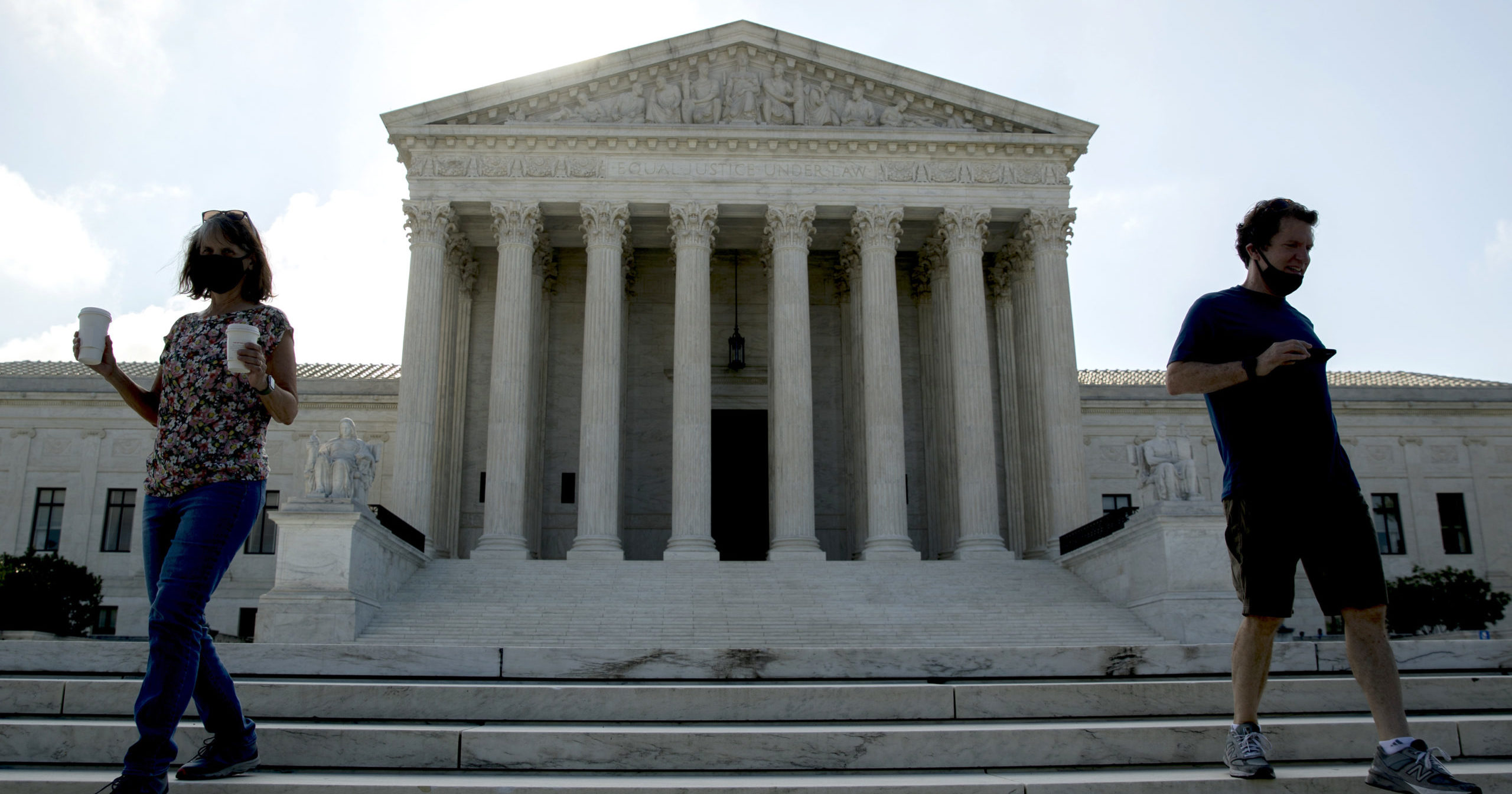 Two people walk down the steps outside the Supreme Court on July 9, 2020, in Washington, D.C.