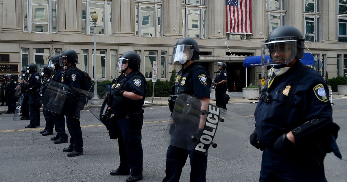 Police hold a perimeter near the White House as protesters gather on June 2, 2020, in Washington, D.C.