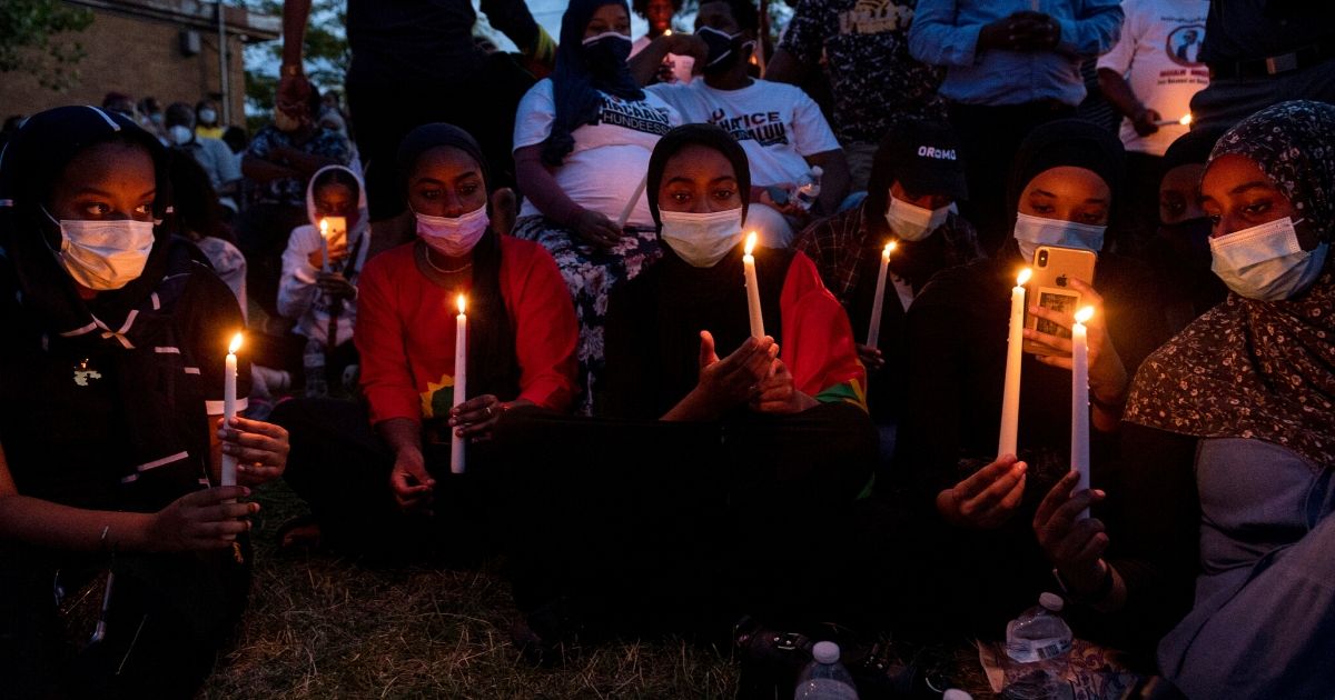 People gather for a candlelight vigil in memory of musician and activist Hachalu Hundessa at the Oromo Community of Minnesota building on June 30, 2020, in St Paul, Minnesota. Hundessa was shot and killed in Addis Ababa, Ethiopia, on June 29.