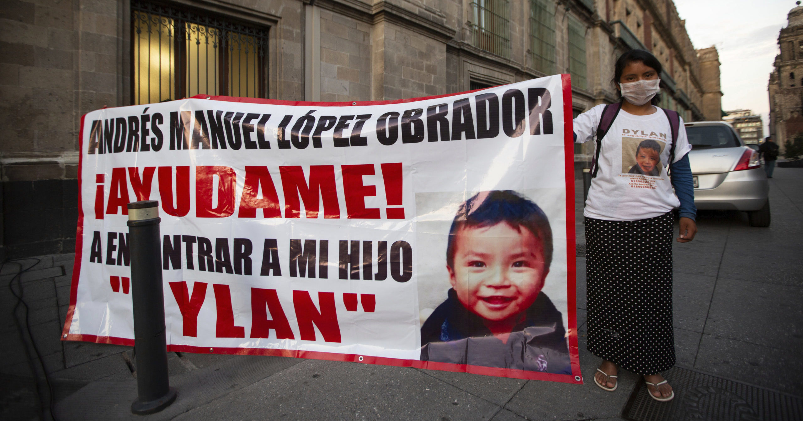 Juana Perez, whose 2-year-old son Dylan is missing, holds a poster of him outside the presidential palace in Mexico City on July 22, 2020. The search for the boy who was led away from a market in southern Mexico's Chiapas state three weeks ago led police to a horrifying discovery: 23 abducted children being kept in a house and forced to sell trinkets in the street.