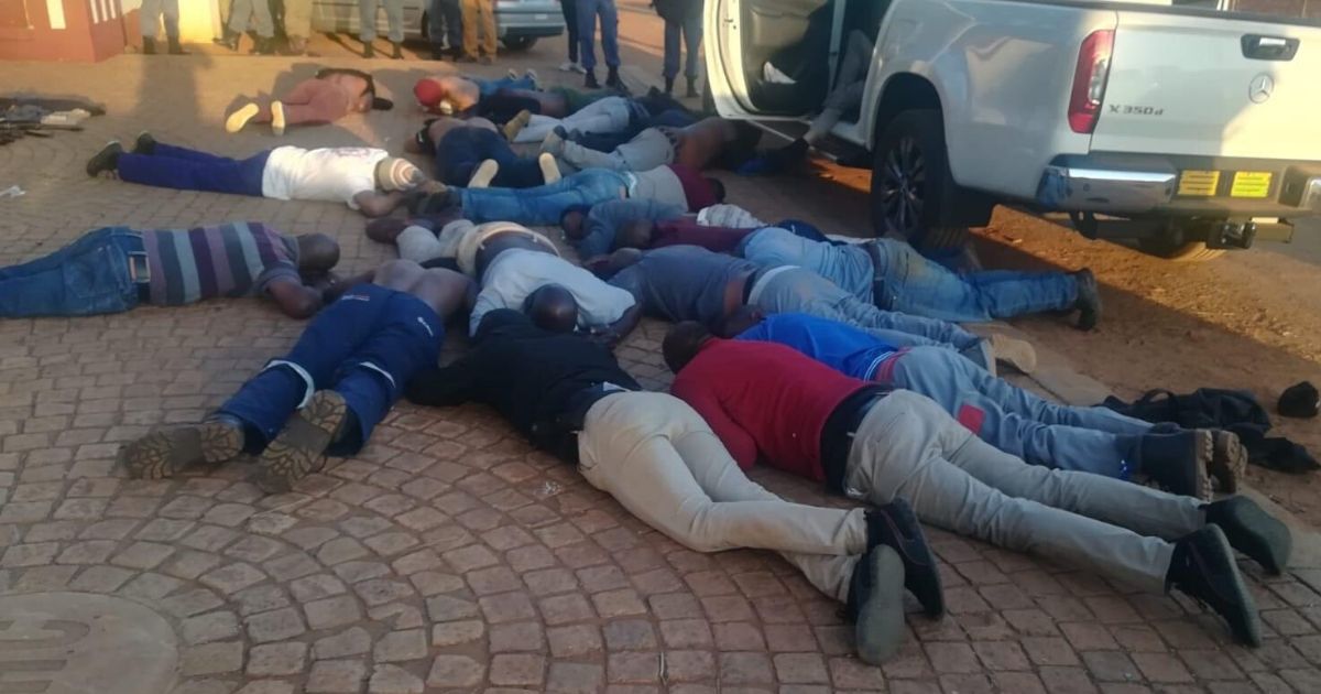 Suspects lie on the ground after a hostage situation unfolded in Johannesburg, South Africa.