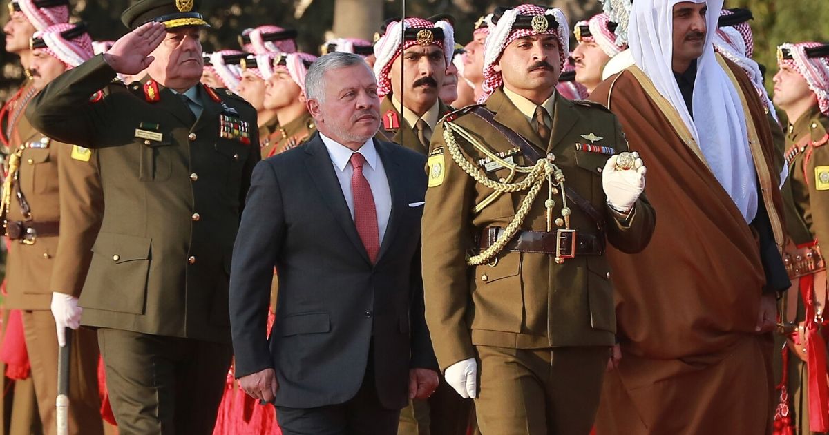 Jordan's King Abdullah II (center) reviews the honor guard at the Queen Alia International Airport in Amman, Jordan, on February 23, 2020.