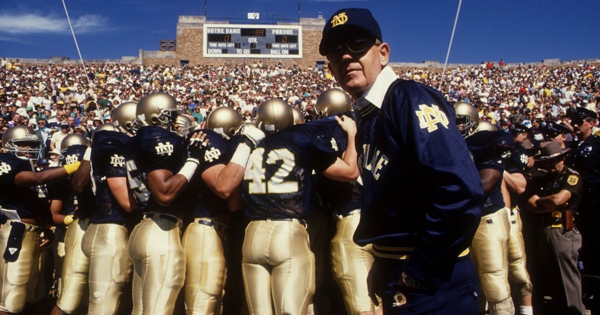 Head coach Lou Holtz of the University of Notre Dame leads his team onto the field prior to a game against Purdue at Notre Dame Stadium in South Bend, Indiana, on Sep. 24, 1988.