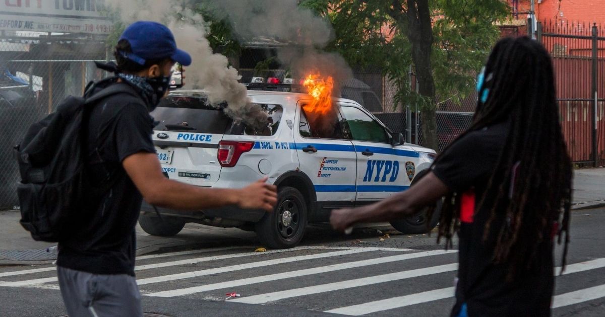 An NYPD police car burns during a protest on May 30, 2020, in the Brooklyn borough of New York City.