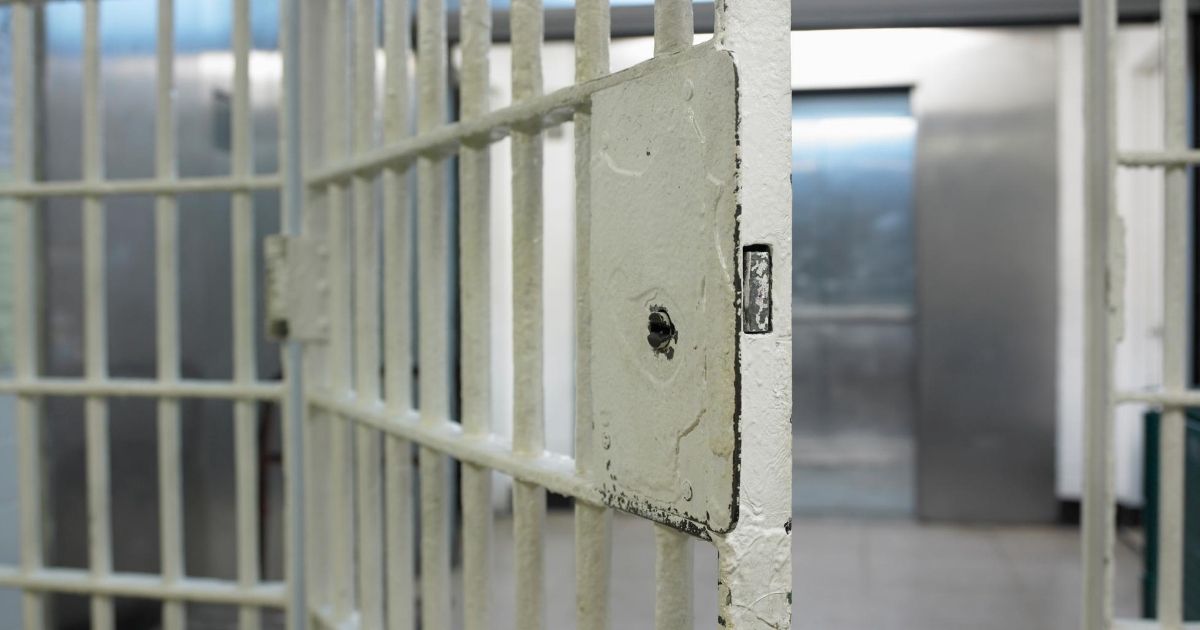 The above stock image shows an open prison door.