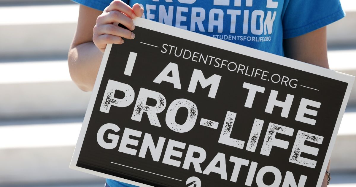 A pro-life activist holds a sign during a demonstration in front of the U.S. Supreme Court on June 29, 2020, in Washington, D.C.
