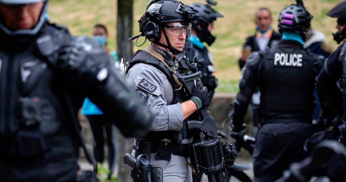 A police officer stands watch in Seattle, Washington, on July 1, 2020.