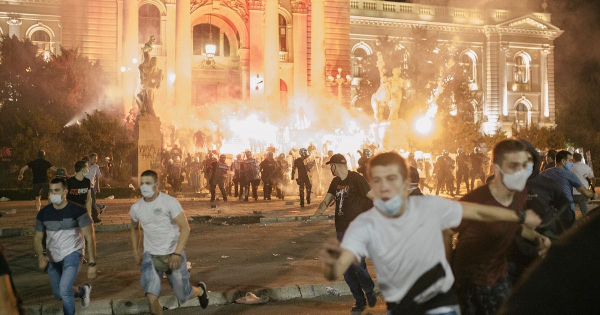 Protesters clash with riot police in Belgrade, Serbia, on July 10, 2020. Hundreds of demonstrators tried to storm Serbia's parliament, clashing with police during the fourth night of protests against the president's new lockdown orders.