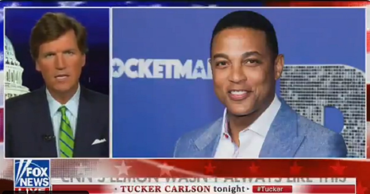 Fox News host Tucker Carlson pictured with a screen shot of CNN's Don Lemon in the background.
