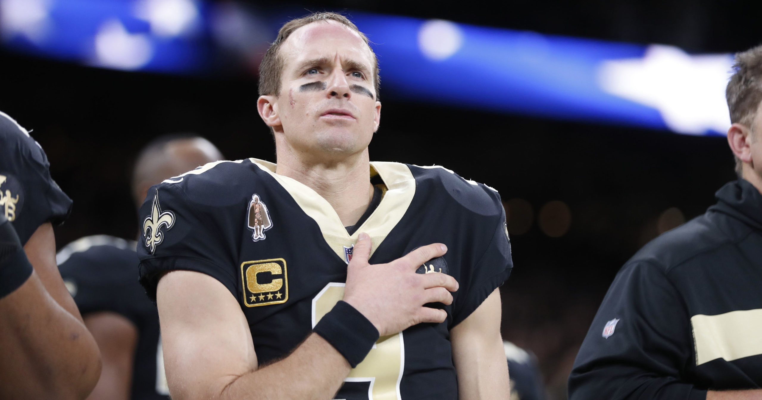 In this Dec. 23, 2018, file photo, New Orleans Saints quarterback Drew Brees holds his hand to his heart during the national anthem before an NFL football game against the Pittsburgh Steelers in New Orleans.