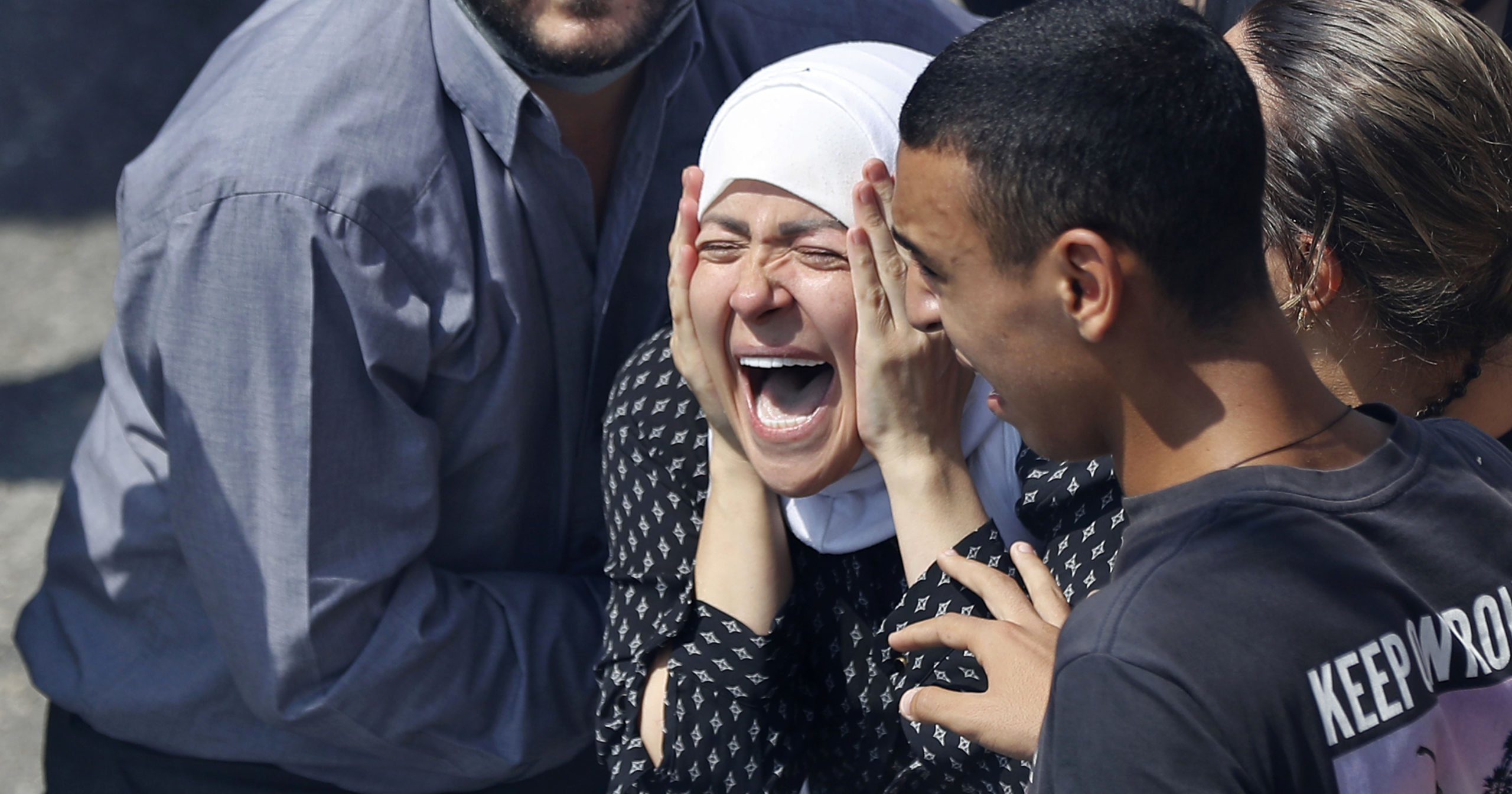 The wife of Rami Kaaki, one of ten firefighters who were killed during last week's explosion at the seaport of Beirut, mourns during her husband's funeral in Beirut, Lebanon, on Aug. 11, 2020.