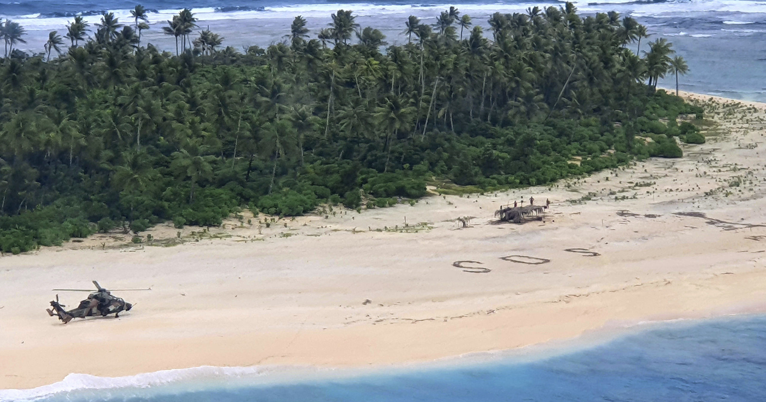 In this photo provided by the Australian Defence Force, an Australian Army helicopter lands on Pikelot Island in the Federated States of Micronesia, where three men were found on Aug. 2, 2020, safe and healthy after missing for three days.