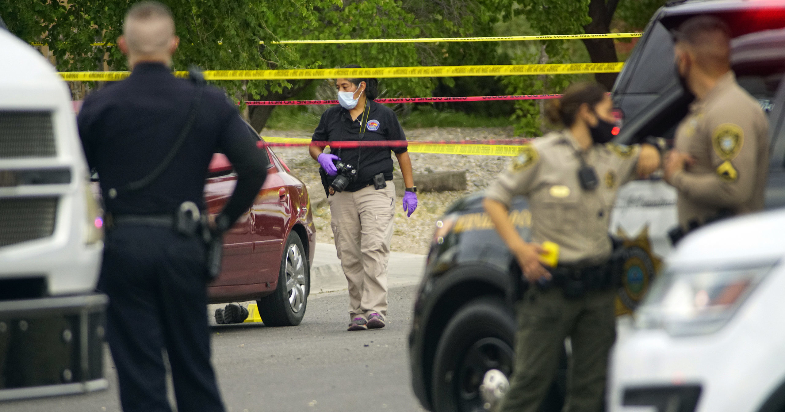 Albuquerque police and Bernalillo County deputies work at the scene of a double shooting on the west side of Albuquerque, New Mexico, the result of a confrontation over a mask on July 21, 2020.