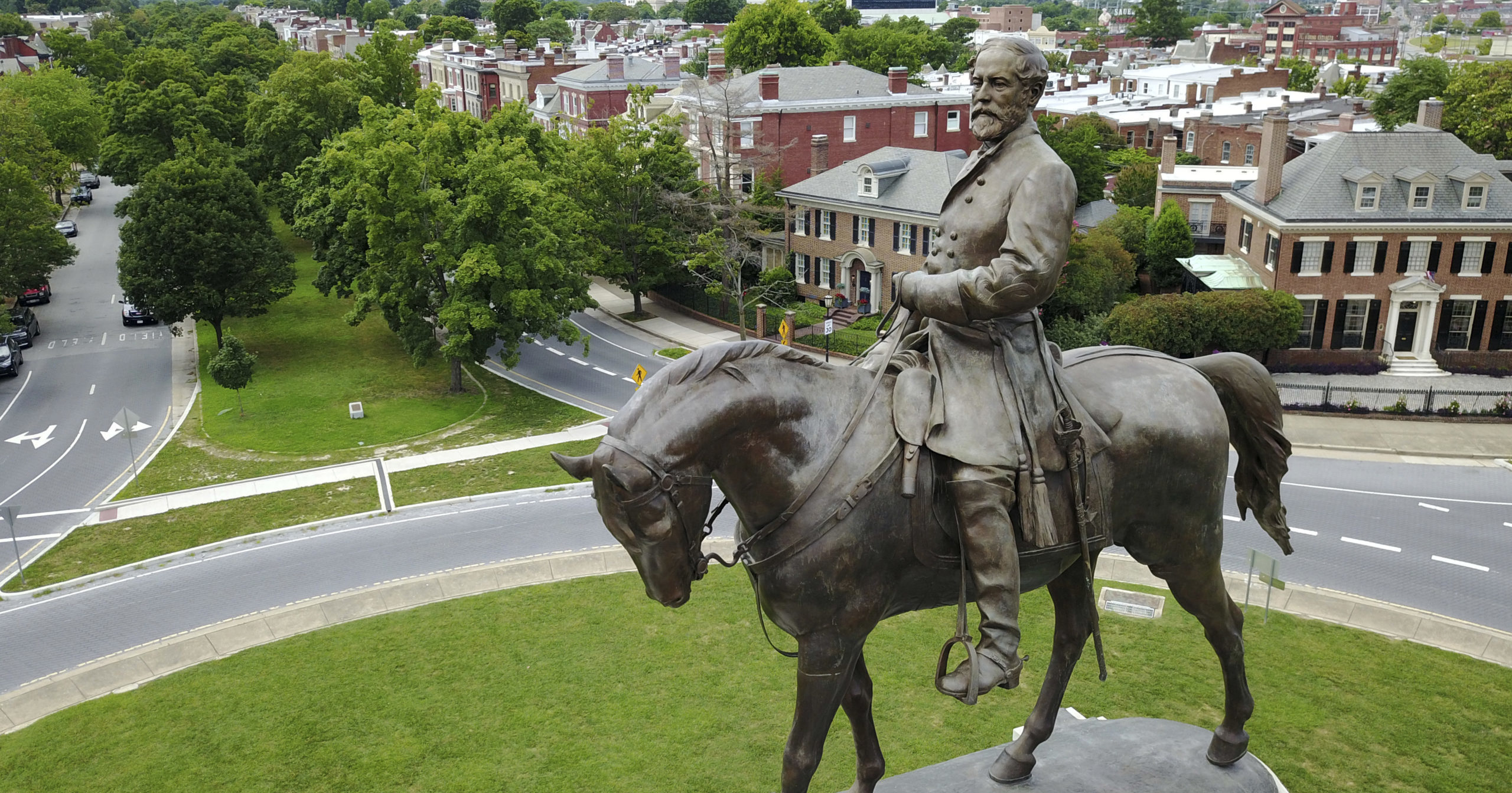 This June 27, 2017, file photo shows the statue of Confederate General Robert E. Lee that stands in the middle of a traffic circle on Monument Avenue in Richmond, Virginia. A lawsuit seeking to prevent Virginia Gov. Ralph Northam’s administration from removing the statue can proceed, a judge ruled on Aug. 25, 2020.