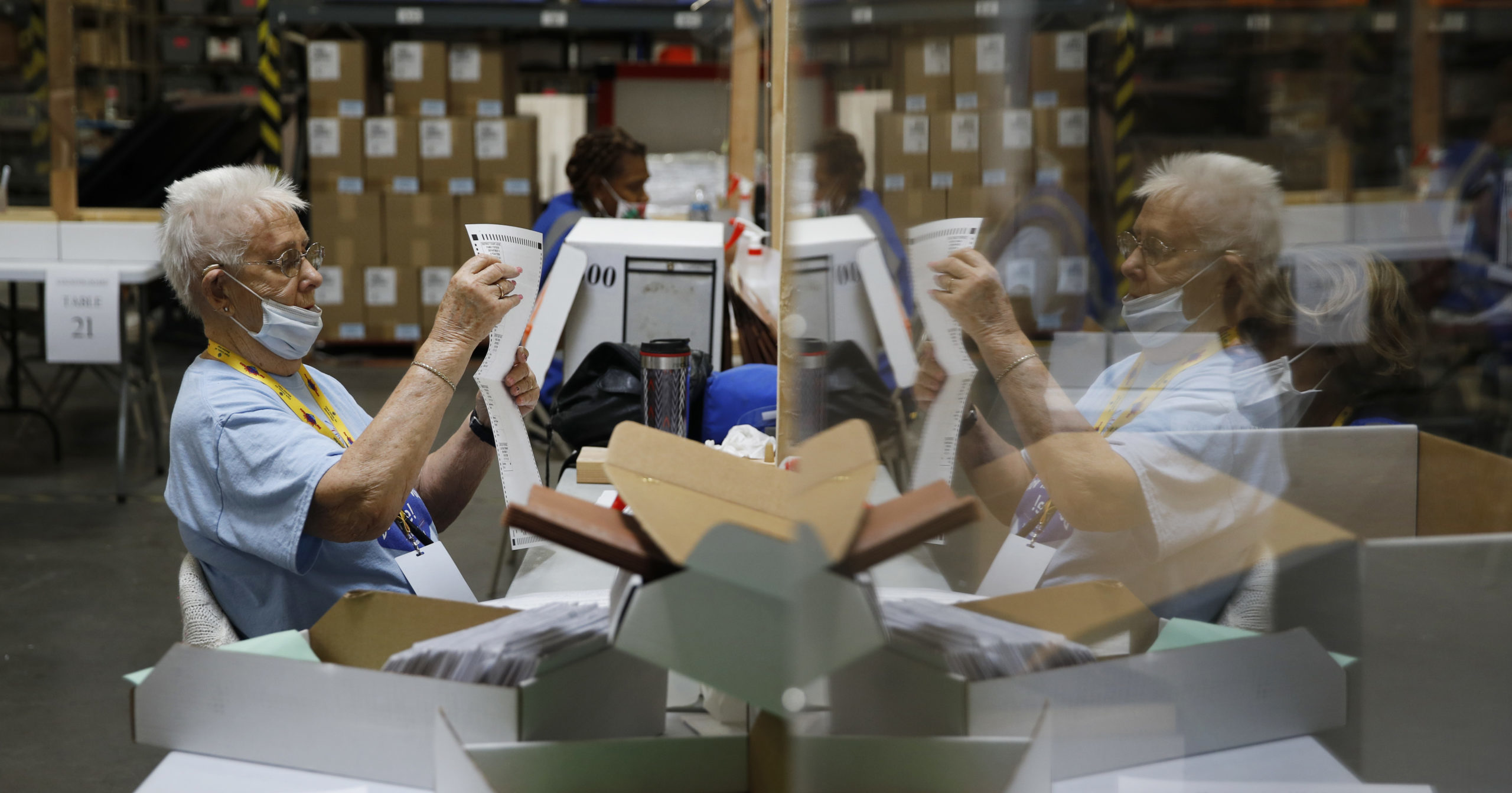 In this June 9, 2020, file photo, election workers process mail-in ballots during a nearly all-mail primary election in Las Vegas.