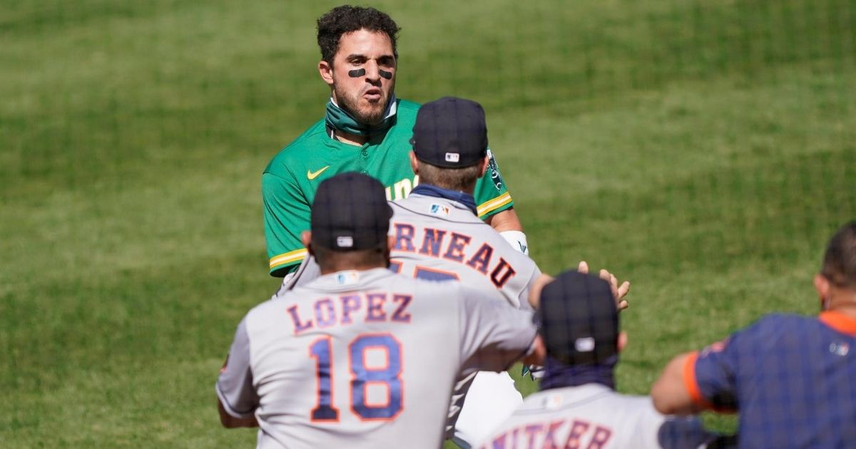 Ramon Laureano of the Oakland Athletics charges towards the Houston Astros dugout after he was hit by a pitch in the bottom of the seventh inning at RingCentral Coliseum on Aug. 9, 2020.