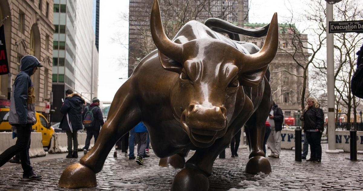 The brass Charging Bull sculpture stands near the Financial District on April 2, 2018, in New York City.
