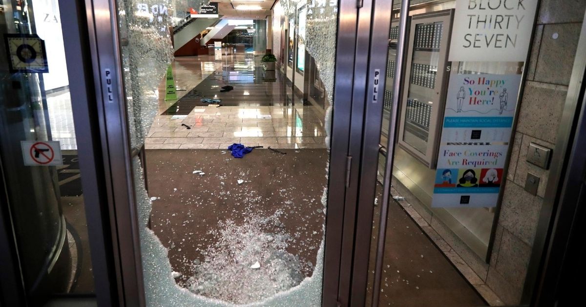 A door to a Chicago retail building is shattered Aug. 10, 2020, after vandals and looters struck the city's famed Loop.