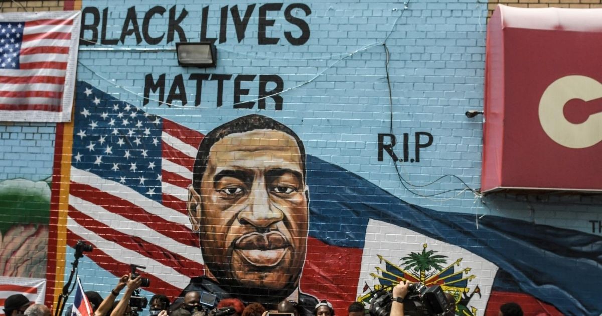 A mural painted by artist Kenny Altidor depicting George Floyd is unveiled on a sidewall of CTown Supermarket on July 13, 2020, in the Brooklyn borough New York City.