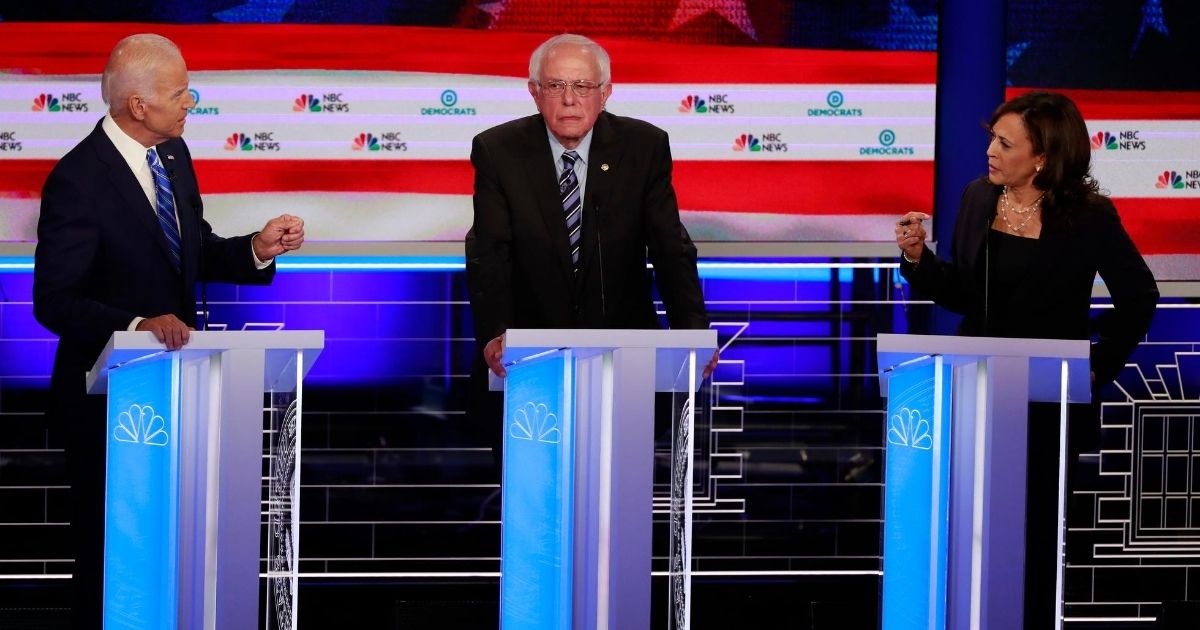 Former Vice President Joe Biden, left, and California Sen. Kamala Harris spar during the Democratic primary debate hosted by NBC News at the Adrienne Arsht Center for the Performing Arts on June 27, 2019, in Miami. Vermont Sen. Bernie Sanders is in the center.