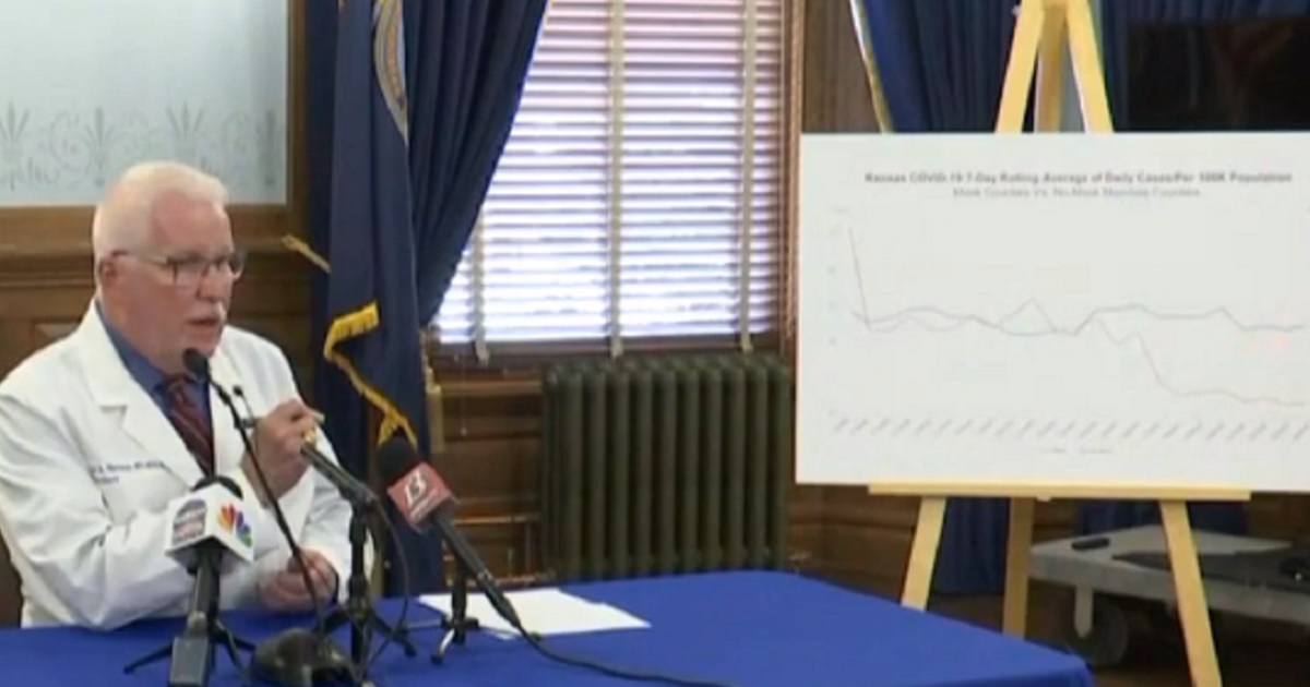 Kansas Department of Health and Environment Secretary Lee Norman gestures at a chart that has been branded as misleading by critics.