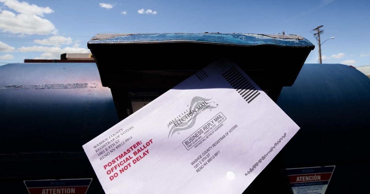 A voter puts a ballot for Nevada's primary election into a mailbox in Reno on June 9, 2020.
