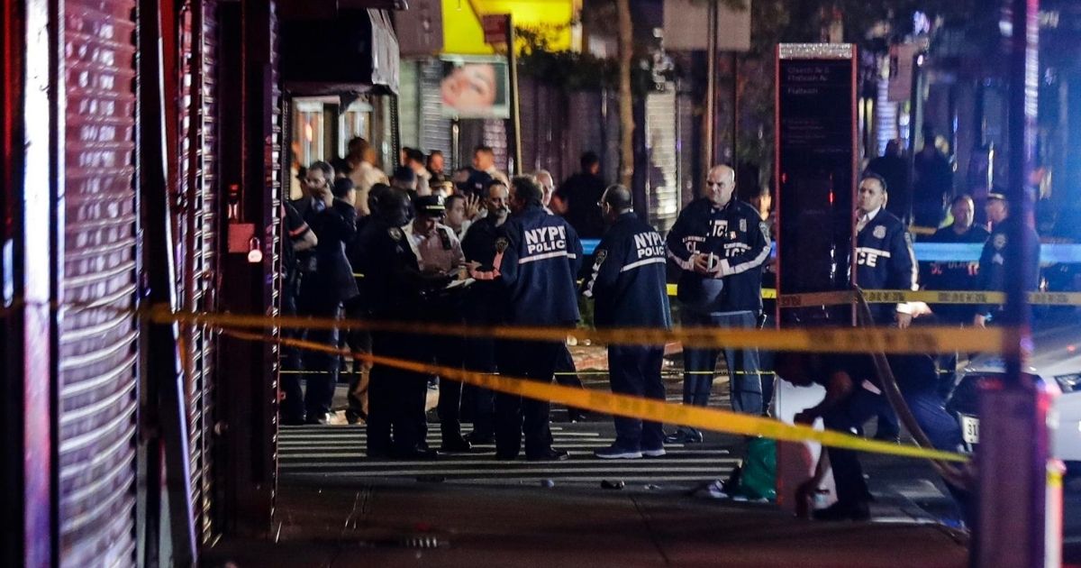 In this June 4, 2020, file photo, New York City police officers gather near the site of shooting in the Brooklyn borough of New York. Dzenan Camovic was indicted Aug, 26, 2020, for allegedly ambushing a New York City police officer on June 4, stabbing him in the neck and stealing his gun to shoot other officers.