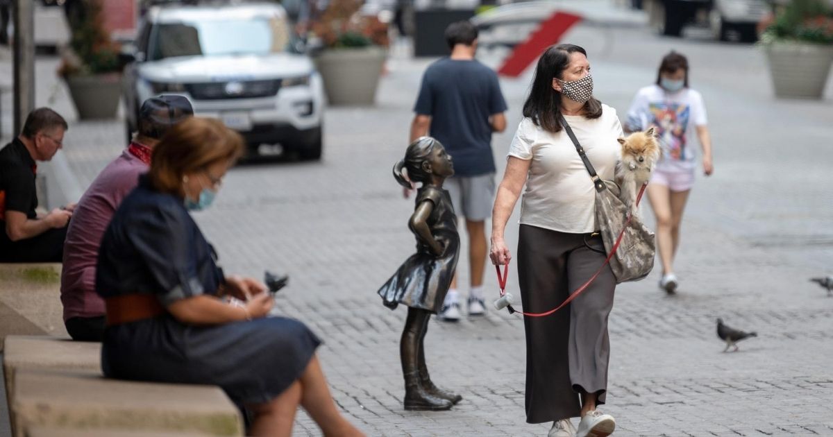A woman wearing a mask walks around in New York City on Aug. 27, 2020.