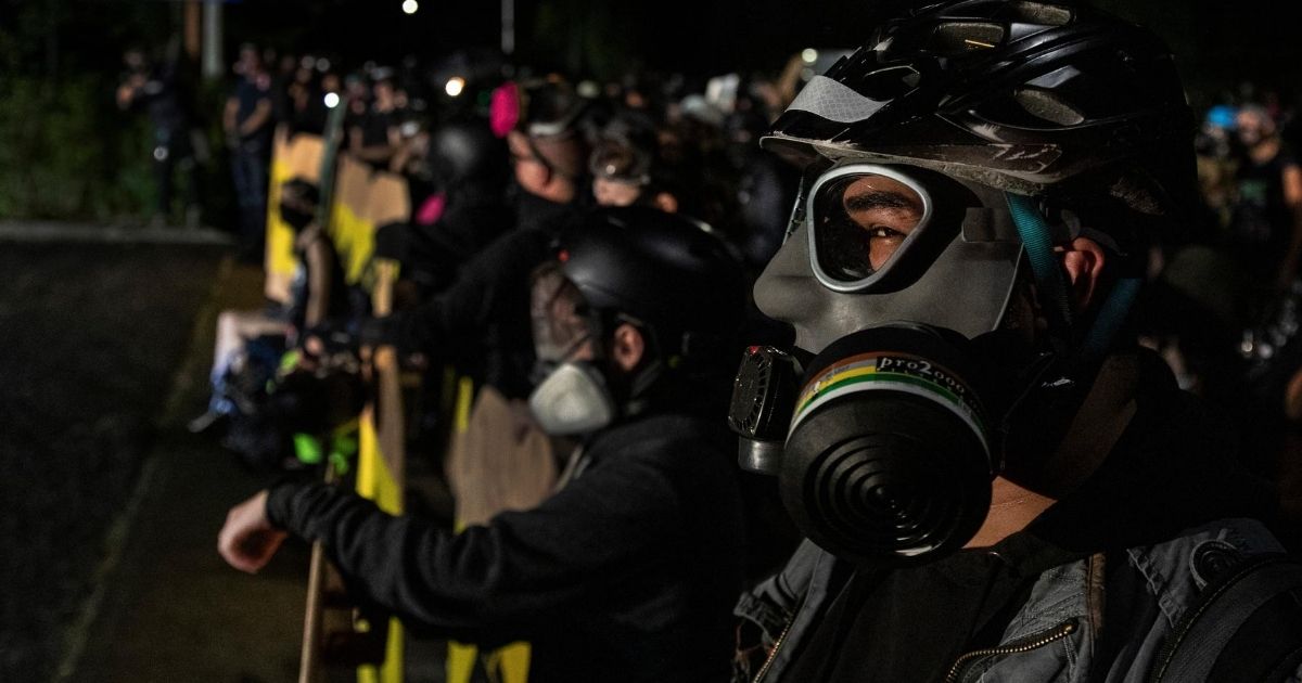 Protesters are seen during a standoff at a Portland police precinct in Portland, Oregon on Aug. 15, 2020.