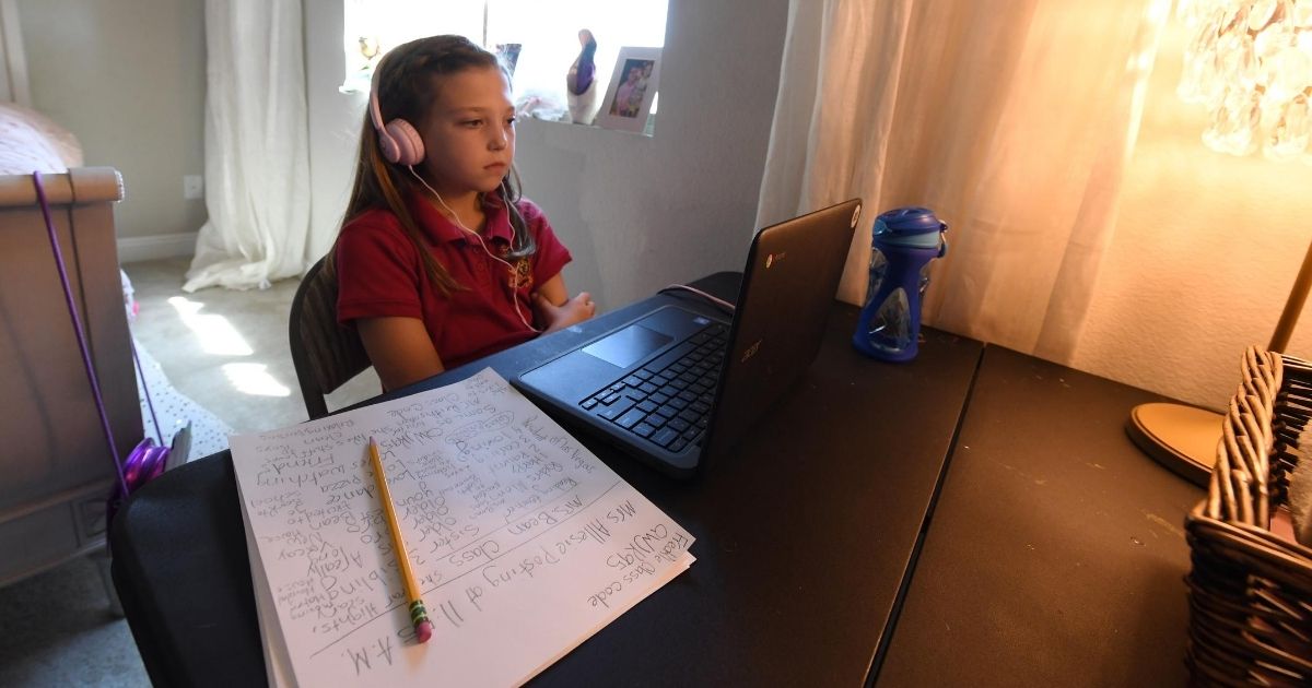 Reaghan Keeler, 9, a fourth-grader at Doral Academy Red Rock Elementary School in Las Vegas, takes part in a reading class from her bedroom on her first day of distance learning Aug. 24, 2020.