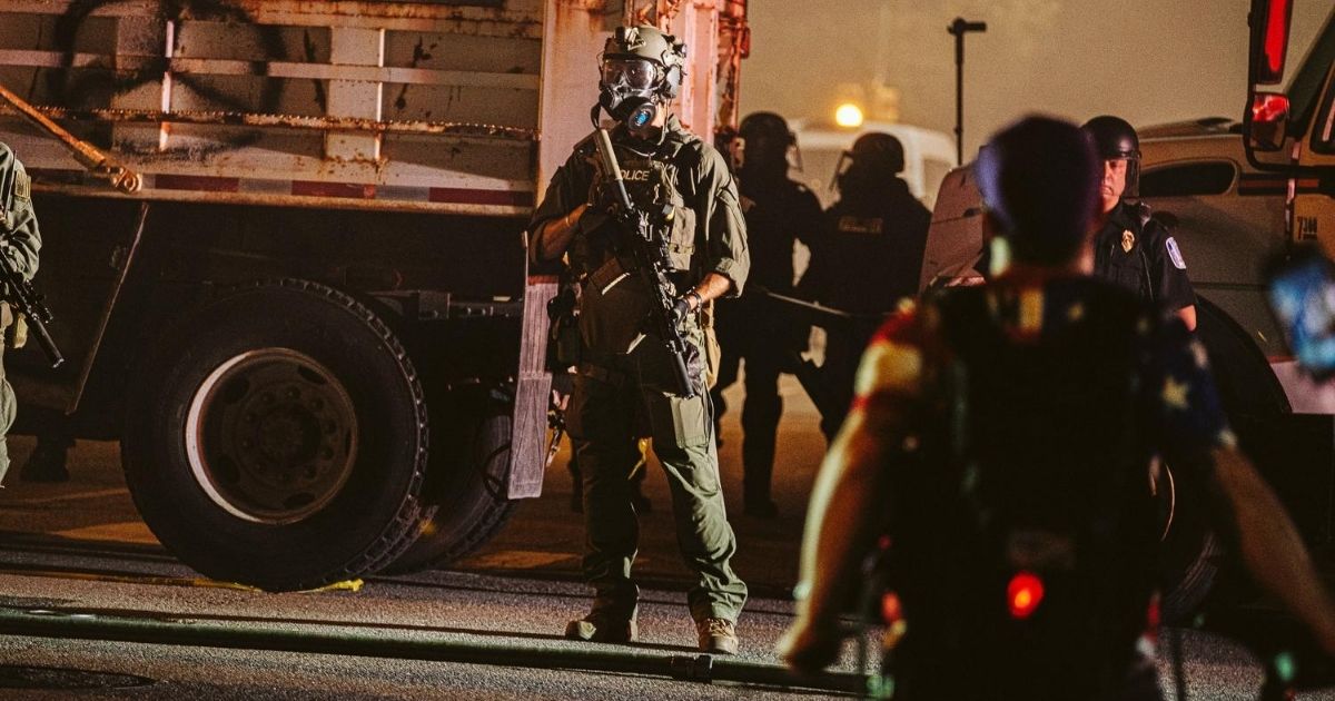 A policeman in a gas mask stands guard on July 25, 2020, in Richmond, Virginia.