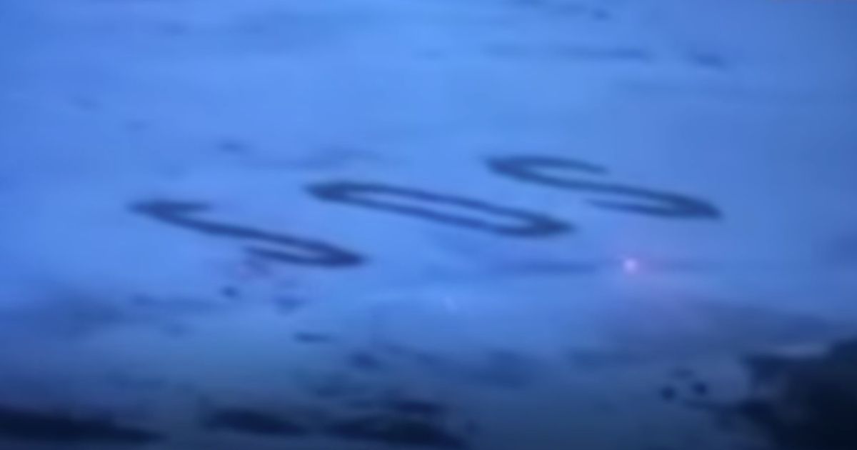 Three mariners were rescued from a remote Pacific island after a helicopter saw their message -- an enormous “SOS” written in the sand.