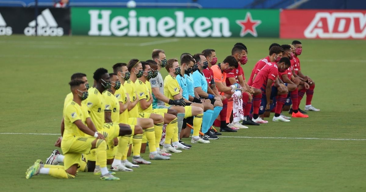 Players from FC Dallas and Nashville SC kneel during the national anthem prior to their game at Toyota Stadium in Frisco, Texas, on Aug. 12, 2020.
