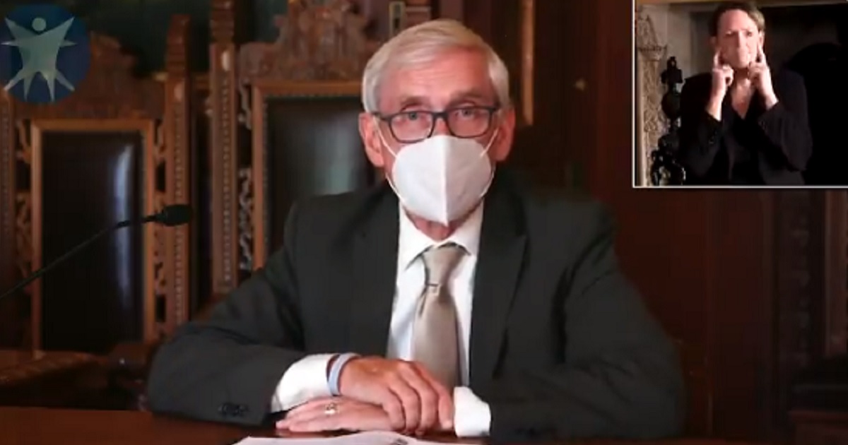 Wisconsin Gov. Tony Evers wears a mask while announcing a statewide mask mandate for Wisconsin residents on July 31.