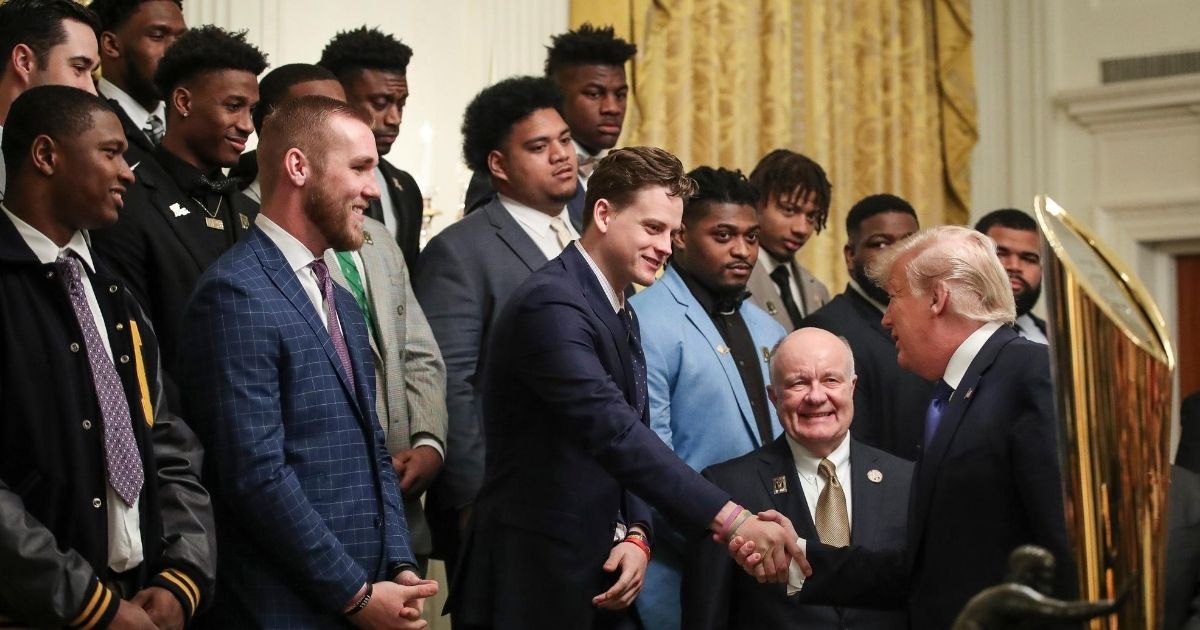 LSU quarterback Joe Burrow shakes hands with President Donald Trump during an event to honor the national champion Tigers in the East Room of the White House on Jan. 17, 2020.