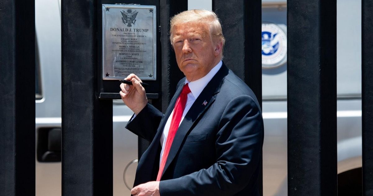 President Donald Trump is pictured before signing a plaque as he participates in a ceremony commemorating the 200th mile of border wall at the international border with Mexico in San Luis, Arizona, on June 23.