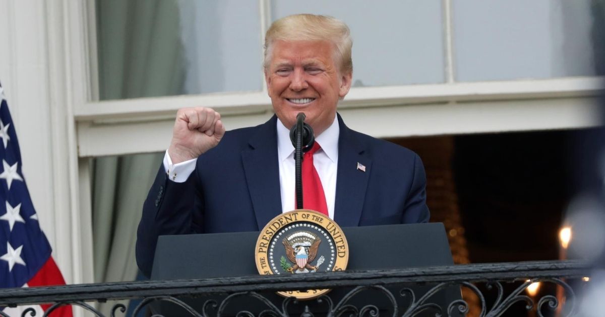 President Donald Trump pumps his fist from the Truman Balcony at the White House during the "Rolling to Remember Ceremony: Honoring Our Nation’s Veterans and POW/MIA" on May 22.