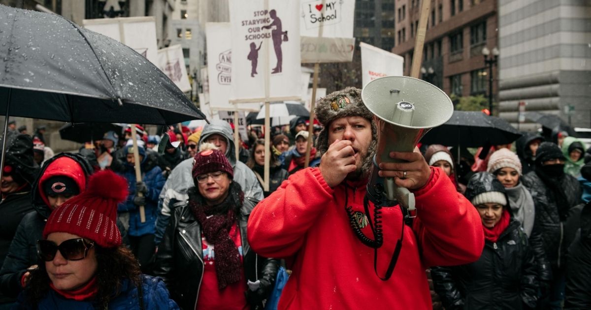 People march through the streets near City Hall during the 11th day of a teachers strike on Oct. 31, 2019, in Chicago.