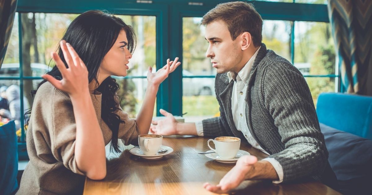 A stock image of a couple arguing in a restaurant is pictured above.