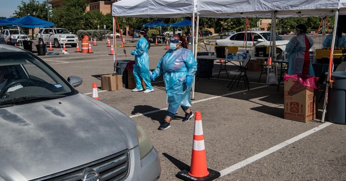 Nurses conduct coronavirus testing at a drive-thru site at El Paso Community College Valle Verde campus on July 21 in El Paso, Texas.