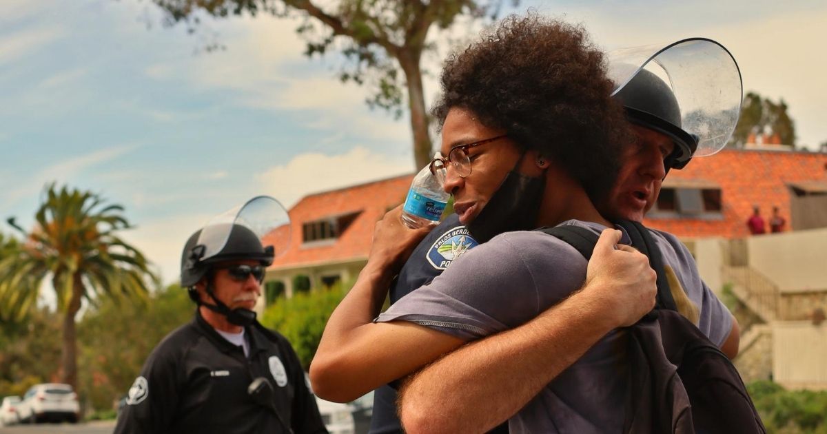 A police officer and protester hug during a June 1 Black Lives Matter demonstration in Los Angeles.
