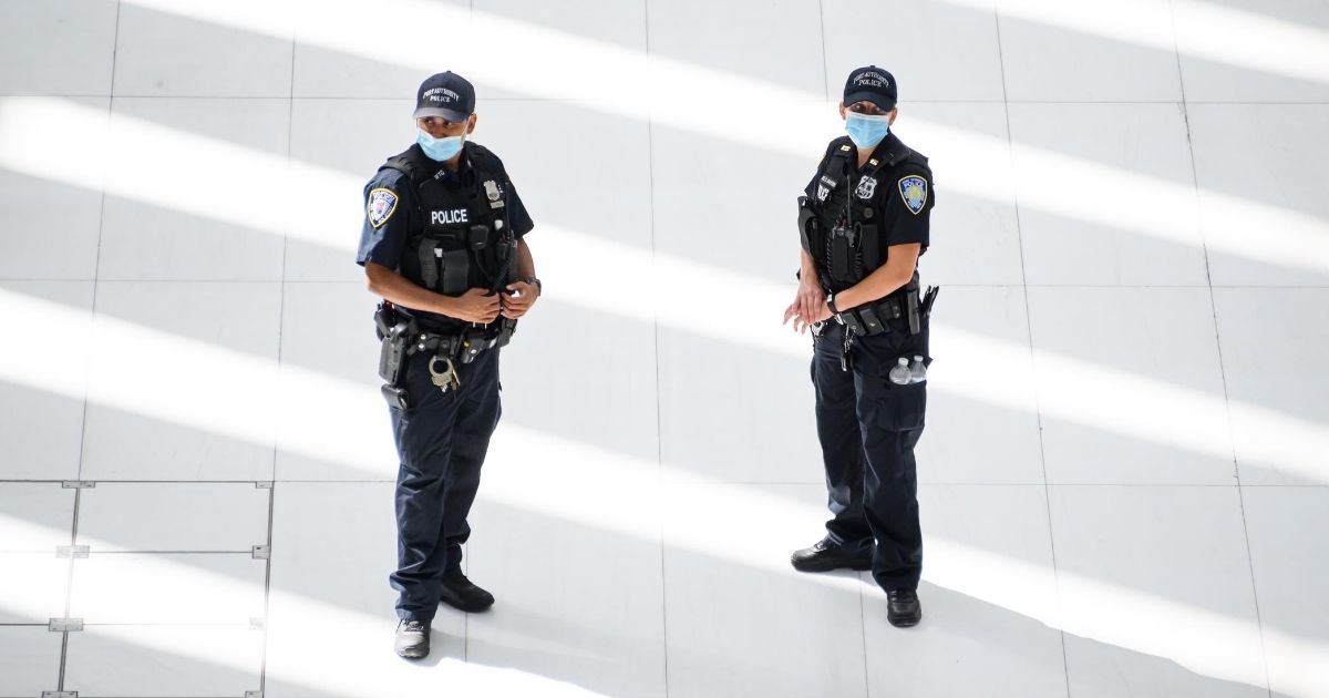 NYPD officers stand in the World Trade Center transportation hub as the city continues Phase 4 of re-opening following restrictions imposed to slow the spread of coronavirus on Aug. 3, 2020, in New York City.