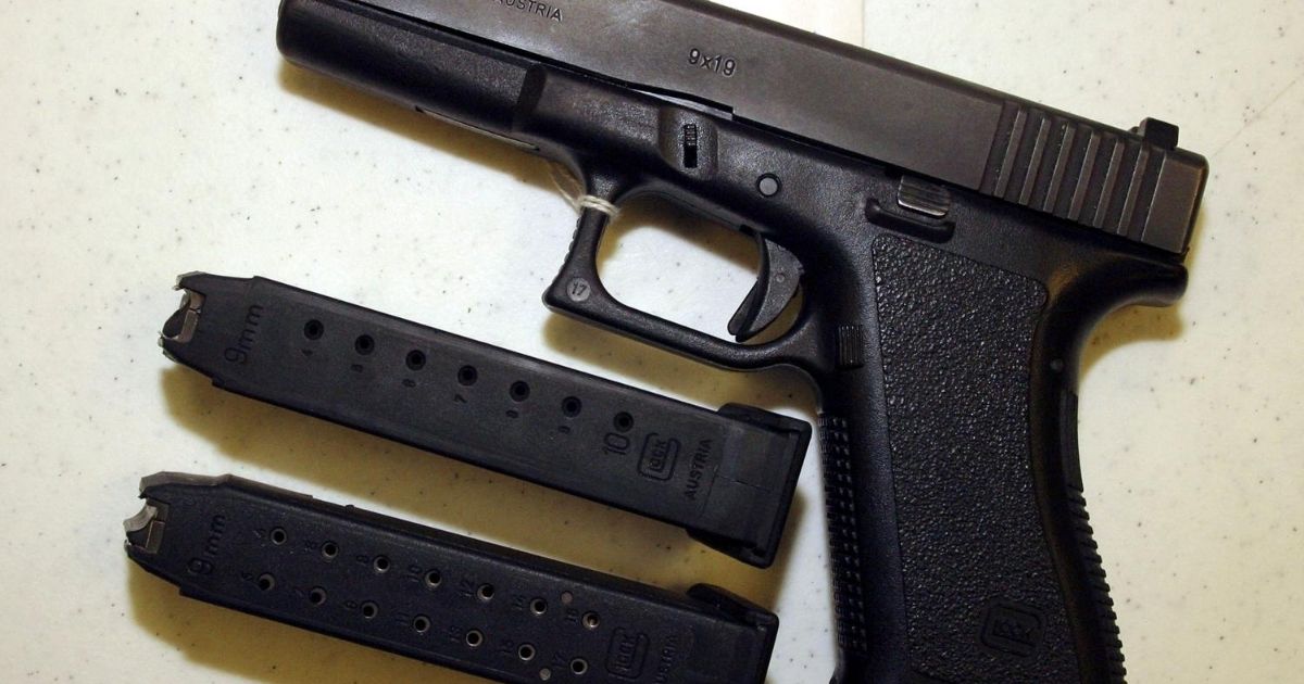 A Glock 9mm pistol is displayed with two different capacity bullet clips at Shooters USA target range in Bossier City, Louisiana, on Sept. 11, 2004.