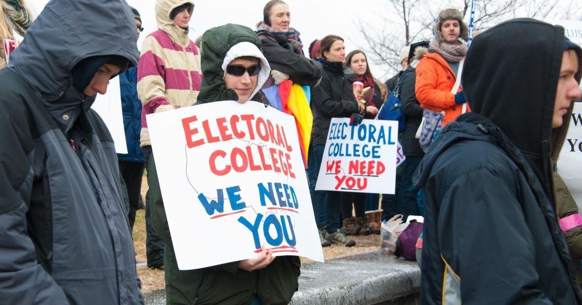 Protesters display signs referencing the Electoral College on Dec. 19, 2016, in Washington, D.C.