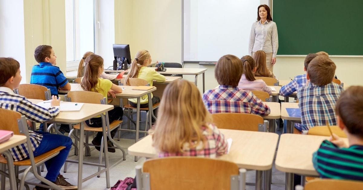 A stock image of an elementary classroom full of students is pictured above.